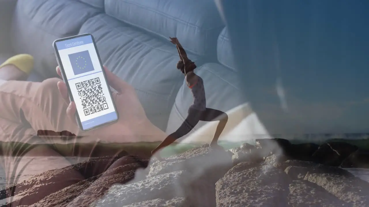 Animation of woman with smartphone with covid passport over woman practicing yoga on beach