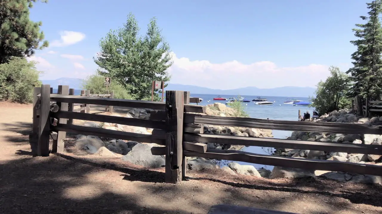 A fence with trees and Lake Tahoe beyond