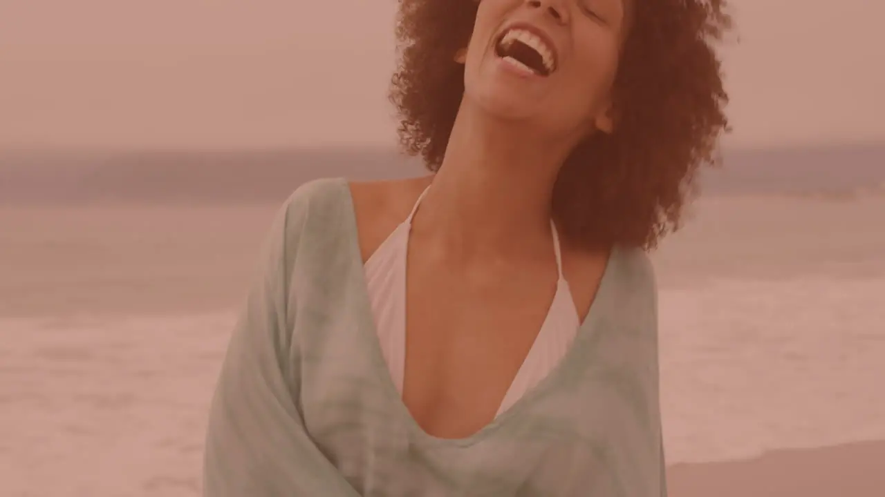 Portrait of african american woman smiling and enjoying at the beach