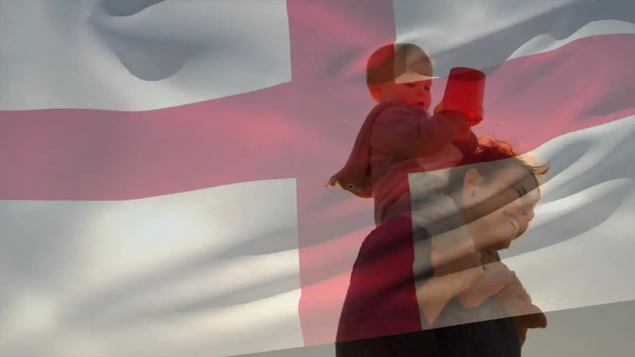 Animation of english flag over happy caucasian mother with child on shoulders on beach