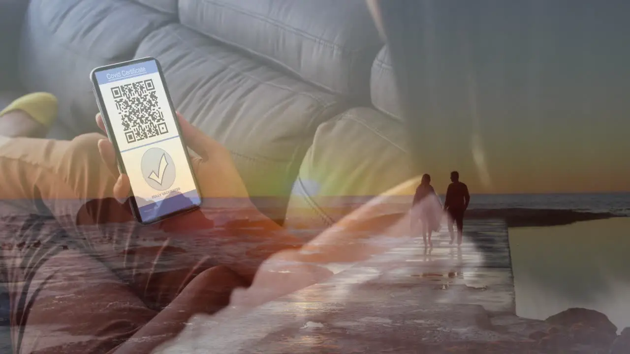 Animation of caucasian woman with smartphone with covid passport over couple on beach