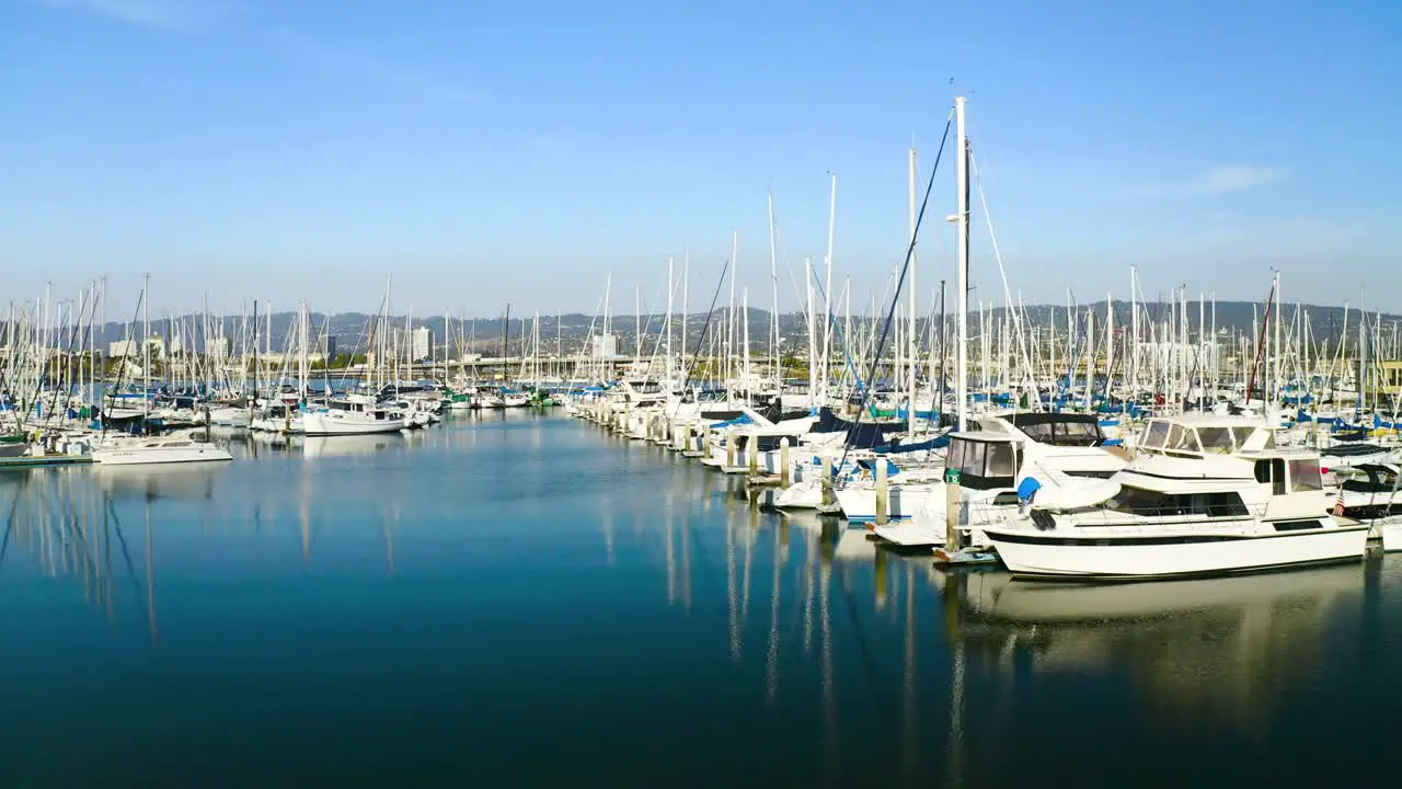 Beautiful sailboats at the marina as the camera slides right on a sunny day