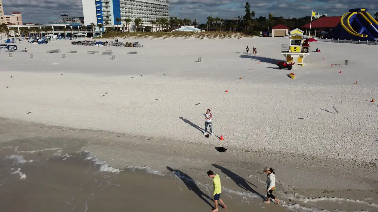 Drone Shot of man standing on a beach revealing the landscape