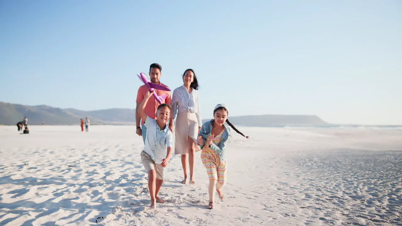 Parents children and airplane toys at beach