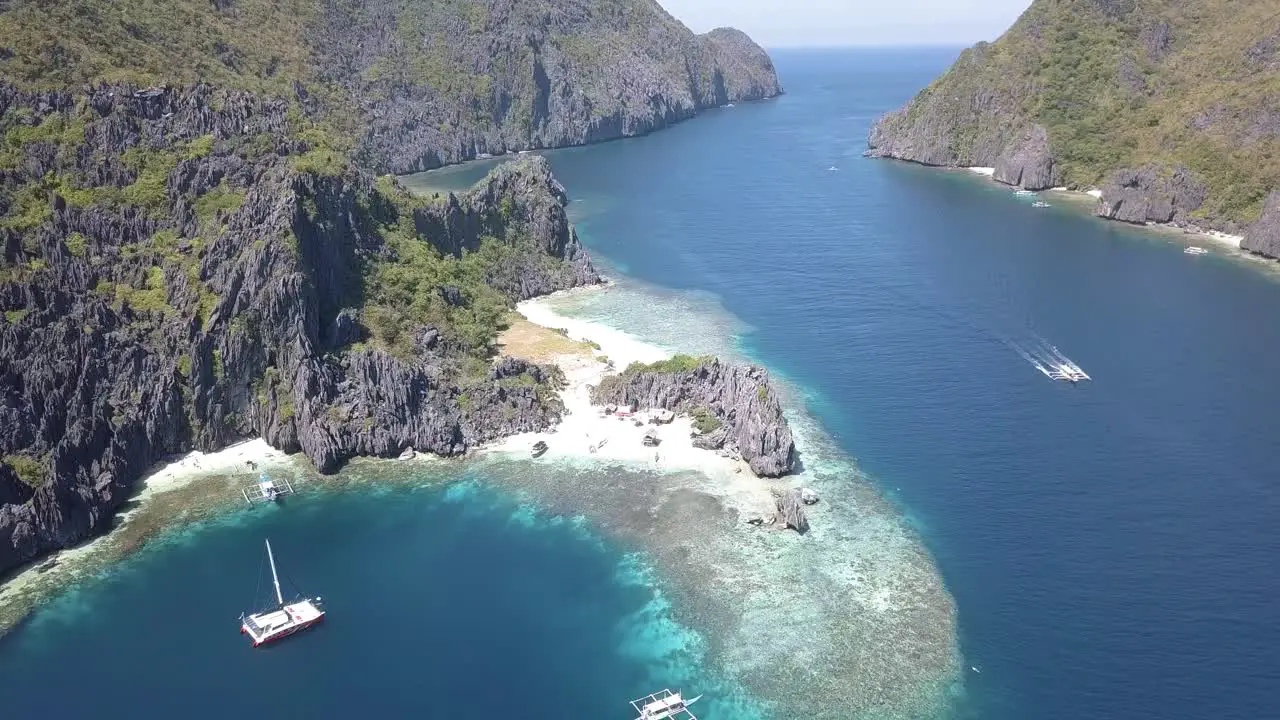 4K Aerial Drone View of Beautiful Private Island in the Philippines with Tour Boat in Distance Star Beach El Nido Palawan