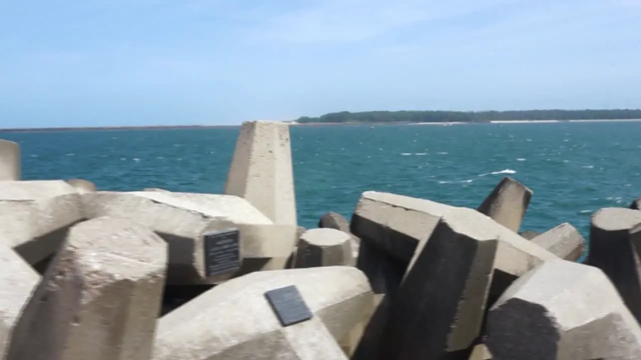 Dolly shot of dolos pier with the sea in the background