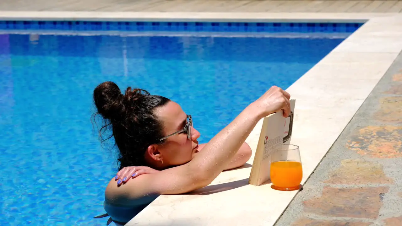 woman reading a book by pool