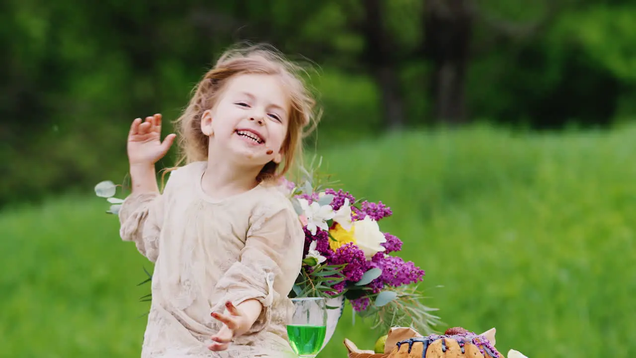 A Funny Smudgy Girl Sits On A Table In The Garden And Eats A Sweet Cake With Her Hands Traces Of Cho