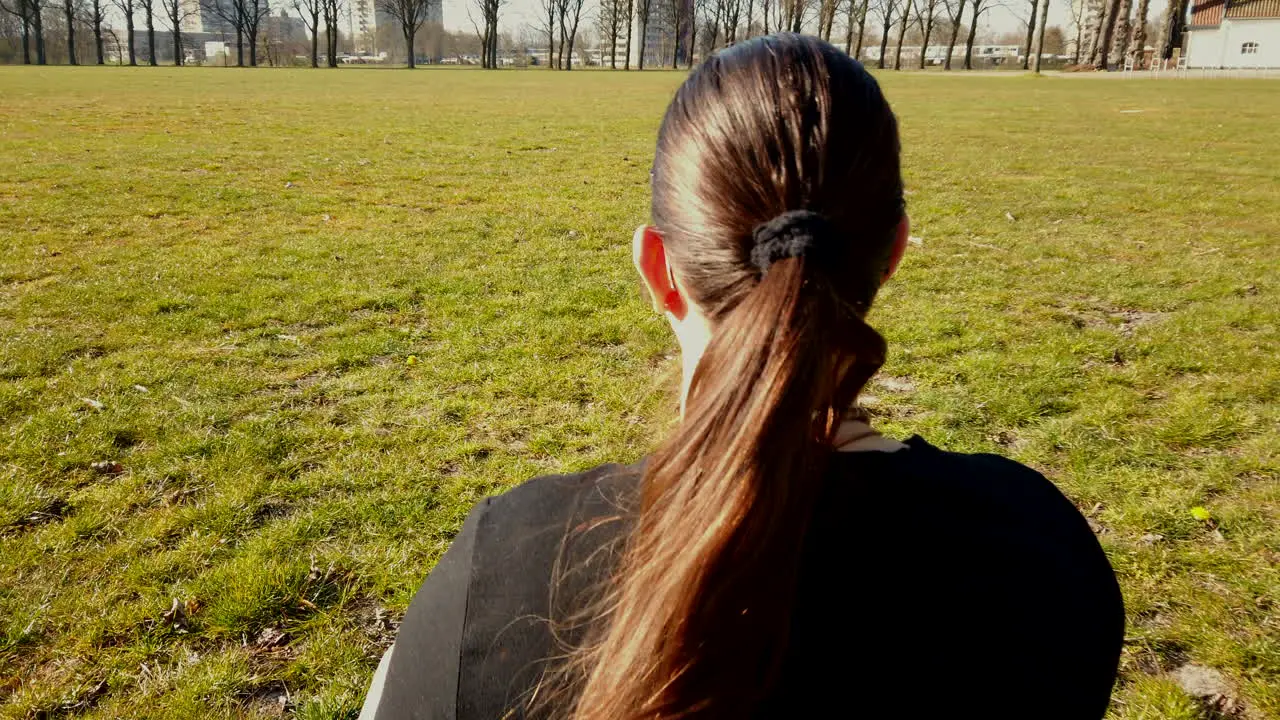 Close up scene of the adult woman is meditating at the quiet park