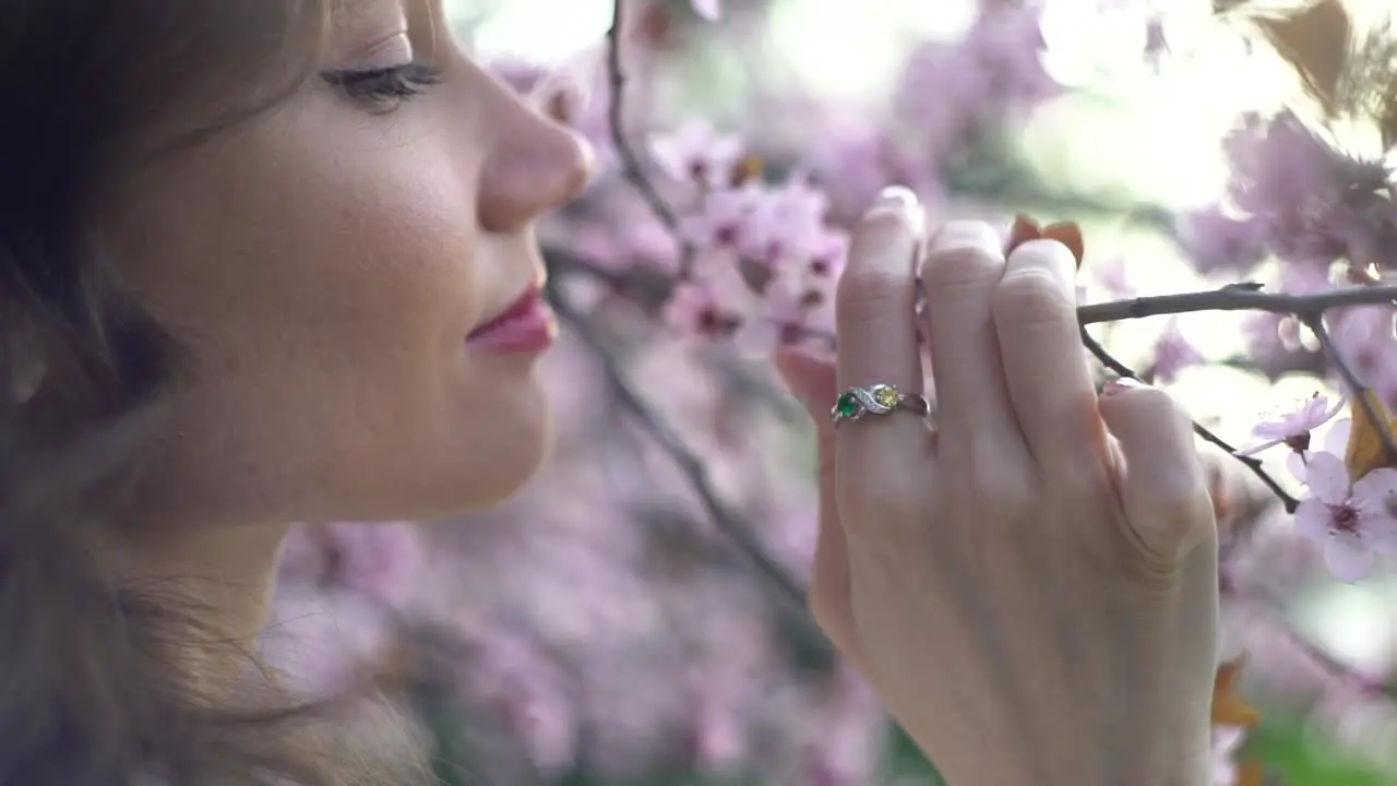 Girl romantically sniffing spring flowers