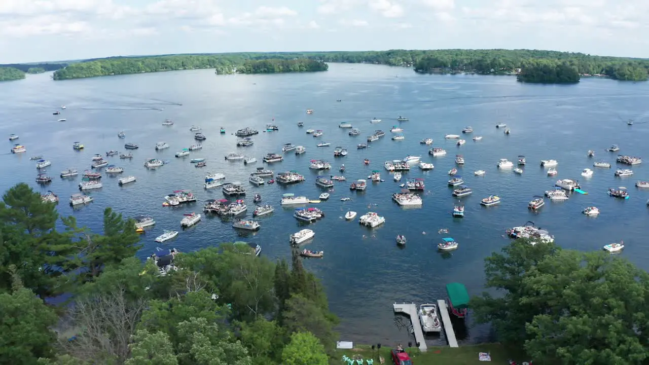 Aerial motor boats crowded on a lake during college spring summer break