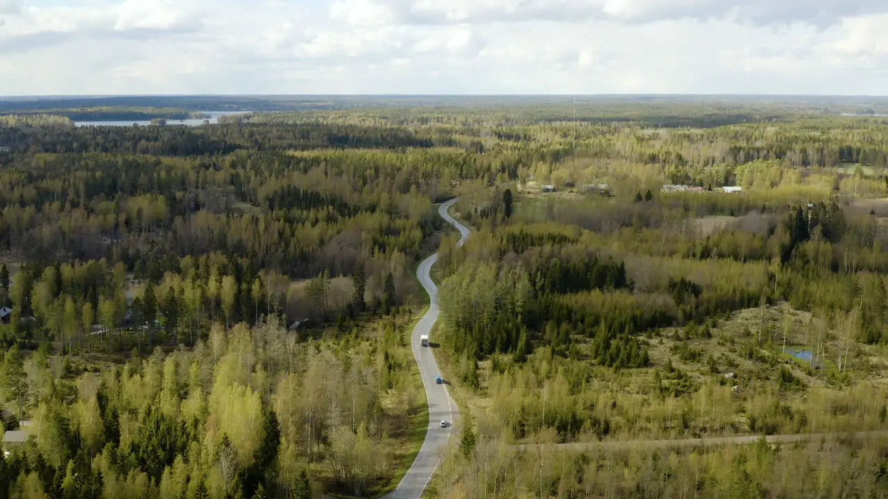 Aerial view overlooking cars and a truck on a road in the Porvoo archipelago on a sunny spring day in the Saaristo of Uusimaa Finland