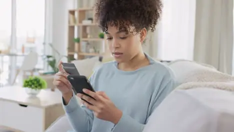 Young woman shopping online using a credit card