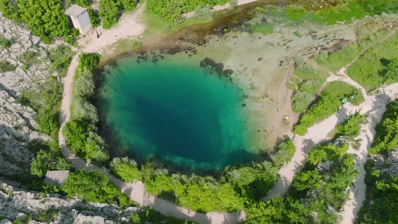 Drone flight over freshwater river spring in Croatia turquoise natural water