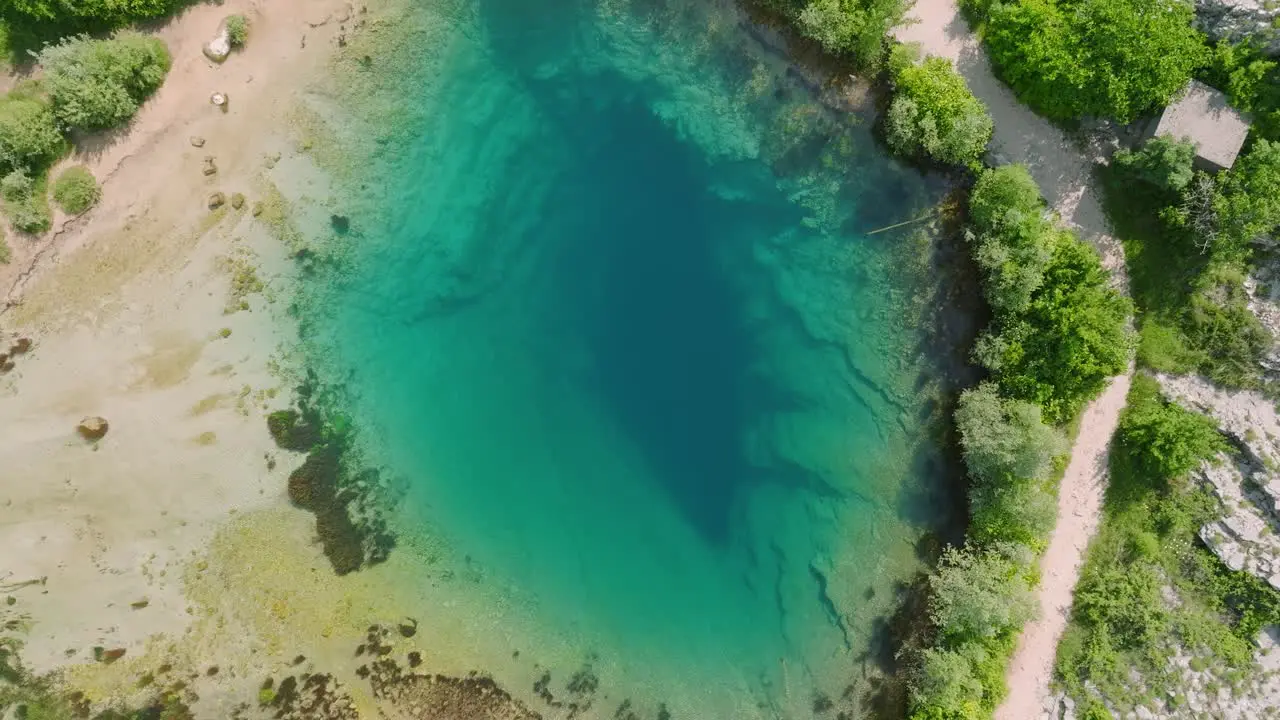 Aerial rotate and lowering turquoise water source of river Cetina Croatia