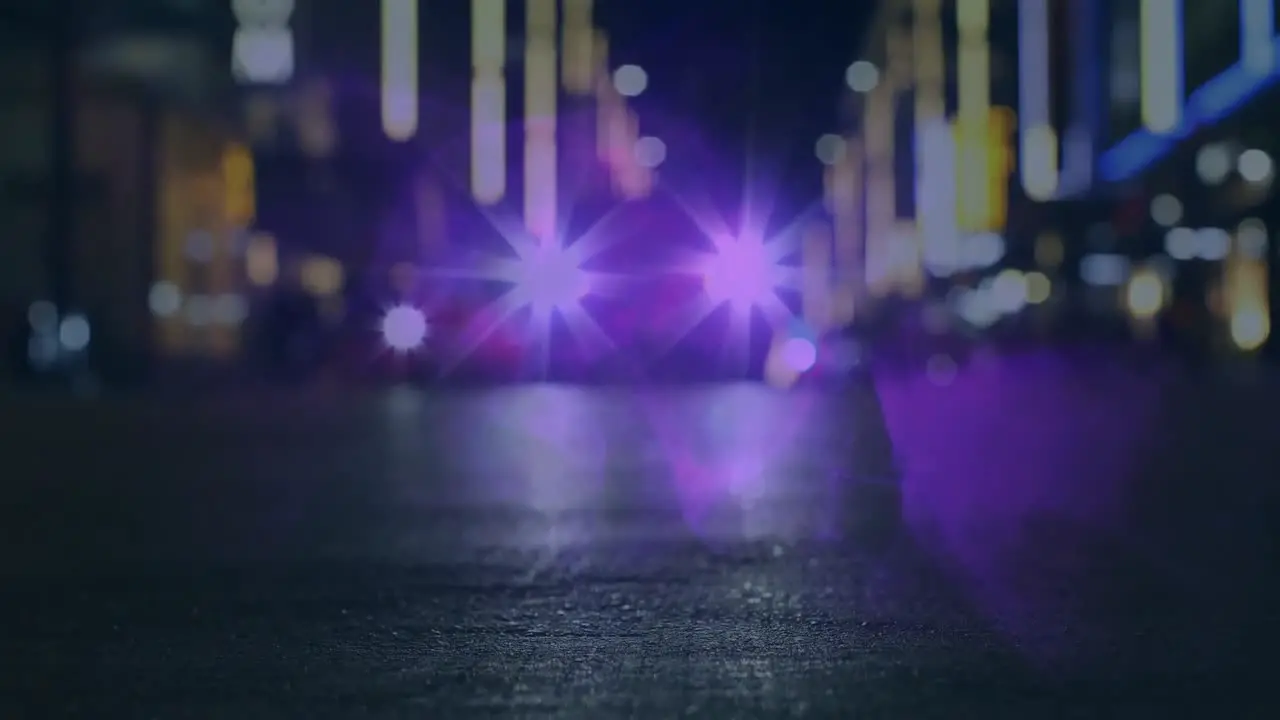 Animation of defocused car with illuminated headlights moving on street against lens flare at night