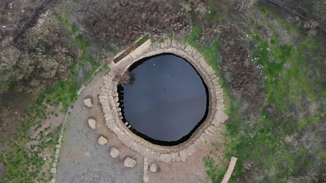 Natural water pool spring Ein Mokesh Israel drone pulling away aerial view