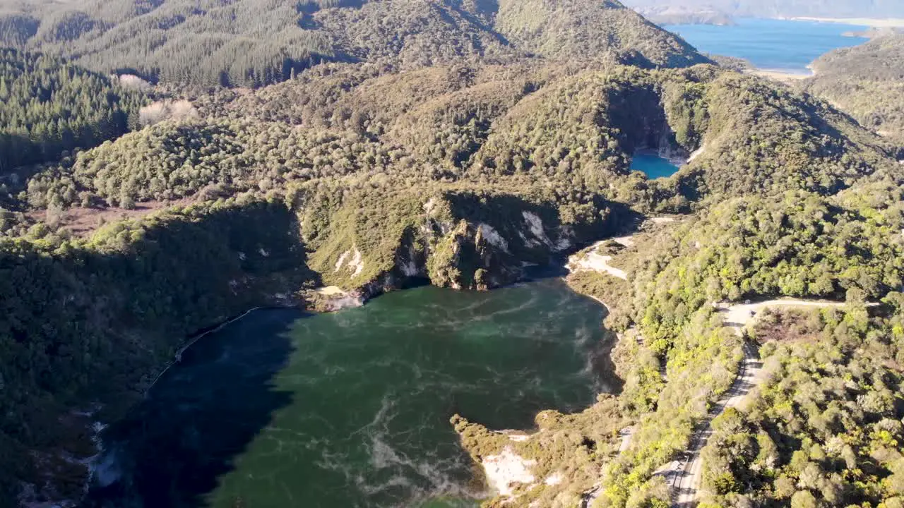 Waimangu Volcanic Valley aerial birds eye view shot of large hot springs and New Zealand landscape