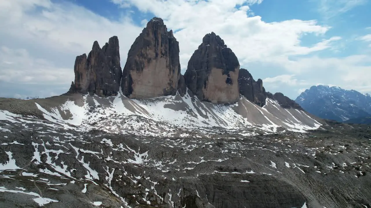 Aerial spring footage of snow-covered Tre Cime di Lavaredo in Dolomiti Italy