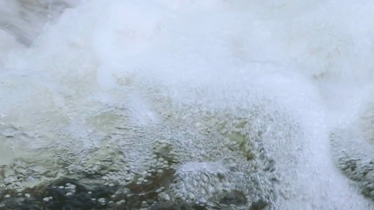 Close up shot of fresh clear spring water bubbling and swirling