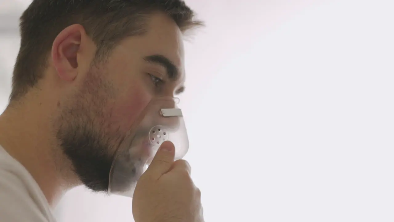 Close Up Of A Sick Man Breathing Through Oxygen Mask 3