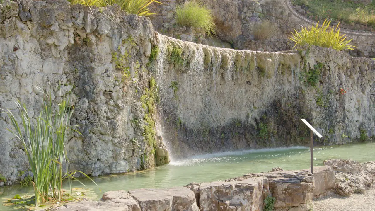 Water trickles down a natural stone fountain