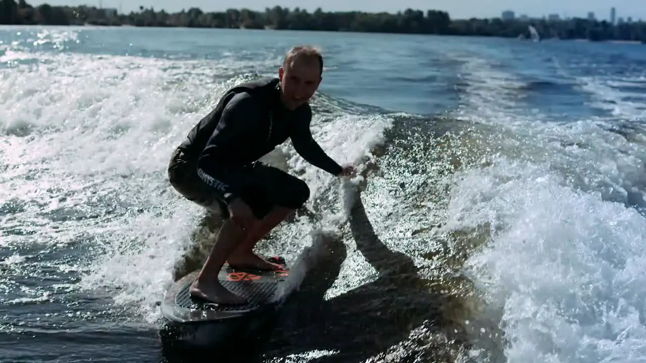 Sportsman wake surfing on waves in slow motion Rider making wake surf stunt