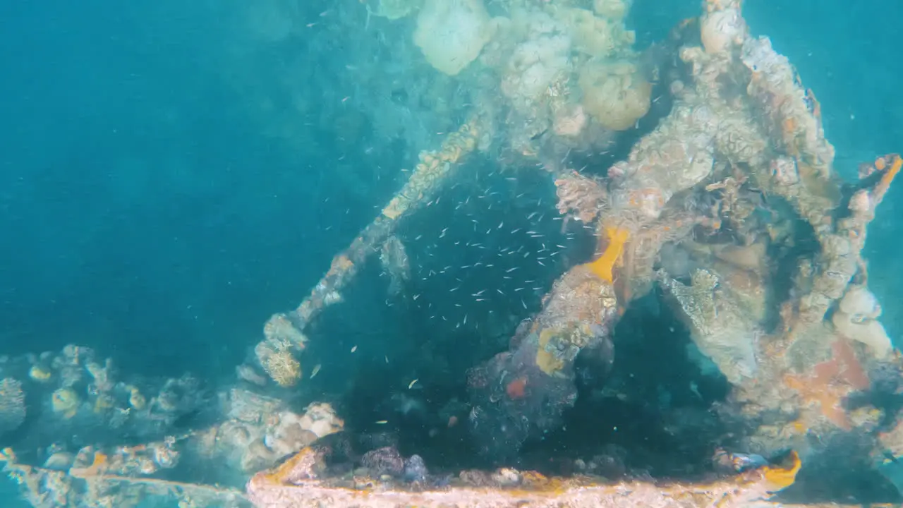 CInematic underwater shot of a ship wreck in clear blue waters in slow motion 4K slomo