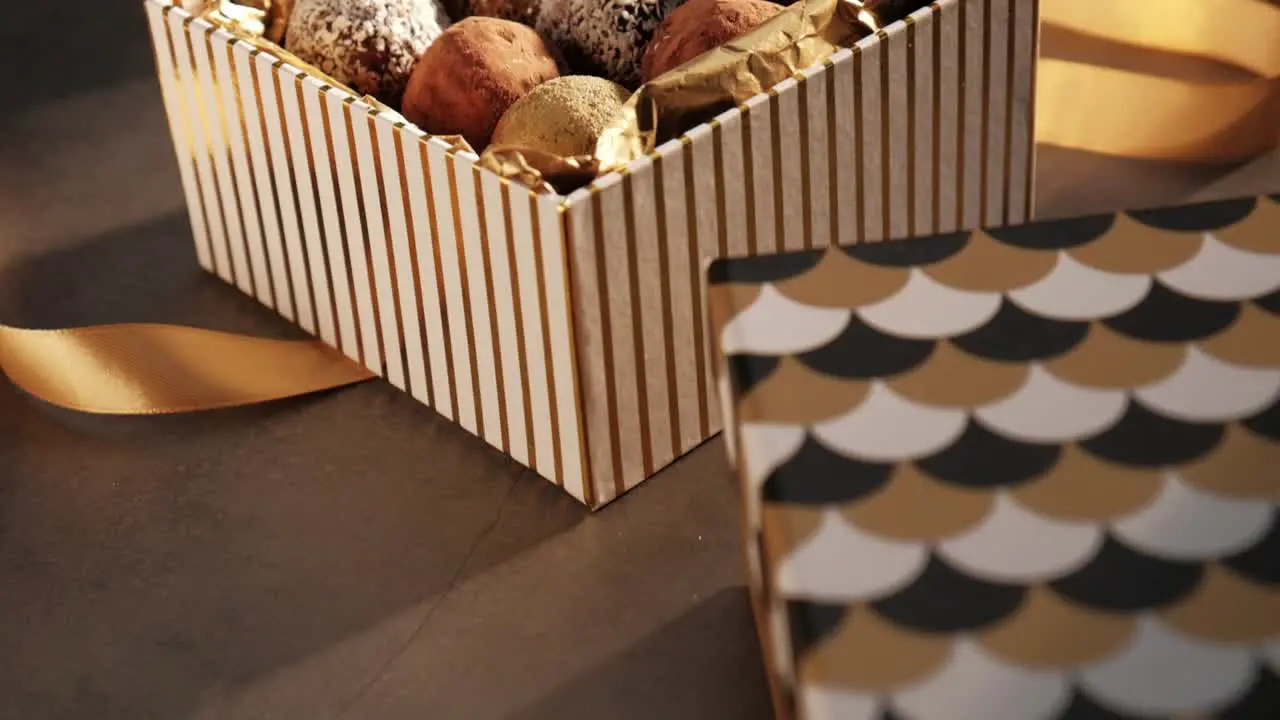 Slowmotion camera move variety of truffles in a gift box