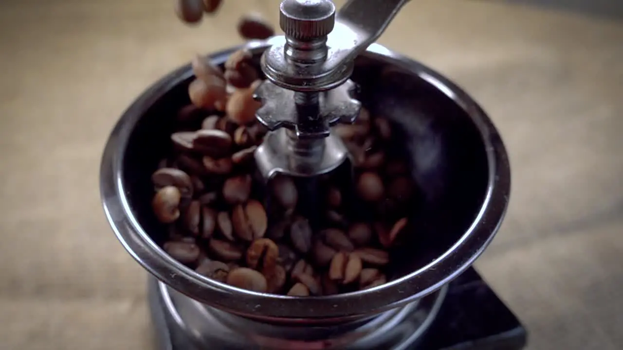 Coffee beans fall in the old grinder Slow motion with rotation tracking shot