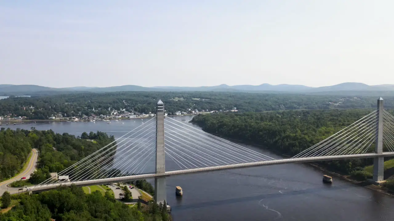 Slow aerial ascent showing bridge spanning river at Bucksport in Maine