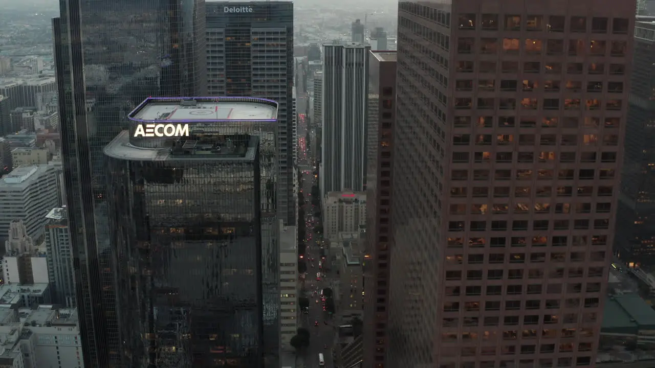 AERIAL Breathtaking flight between huge Skyscrapers in Downtown Los Angeles California Skyline at Sunset