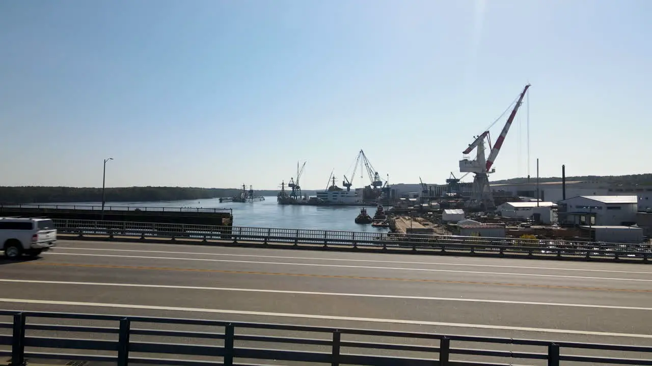 Slow reveal aerial shot of the Bath Iron Works and the River Cranes