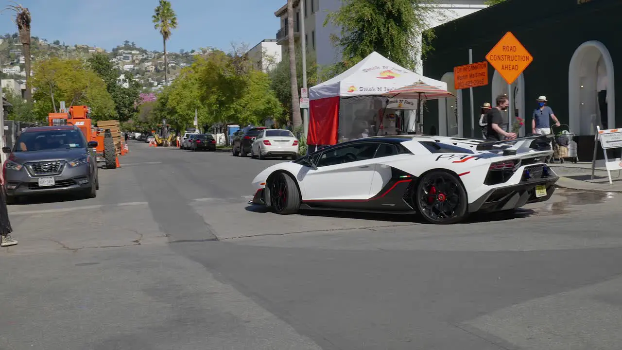 White Black and Red Lamborghini turning off of Melrose Place in West Hollywood California