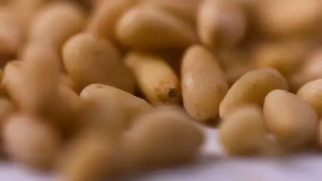 Extreme Close Up Pine Nuts Falling On Flat Surface