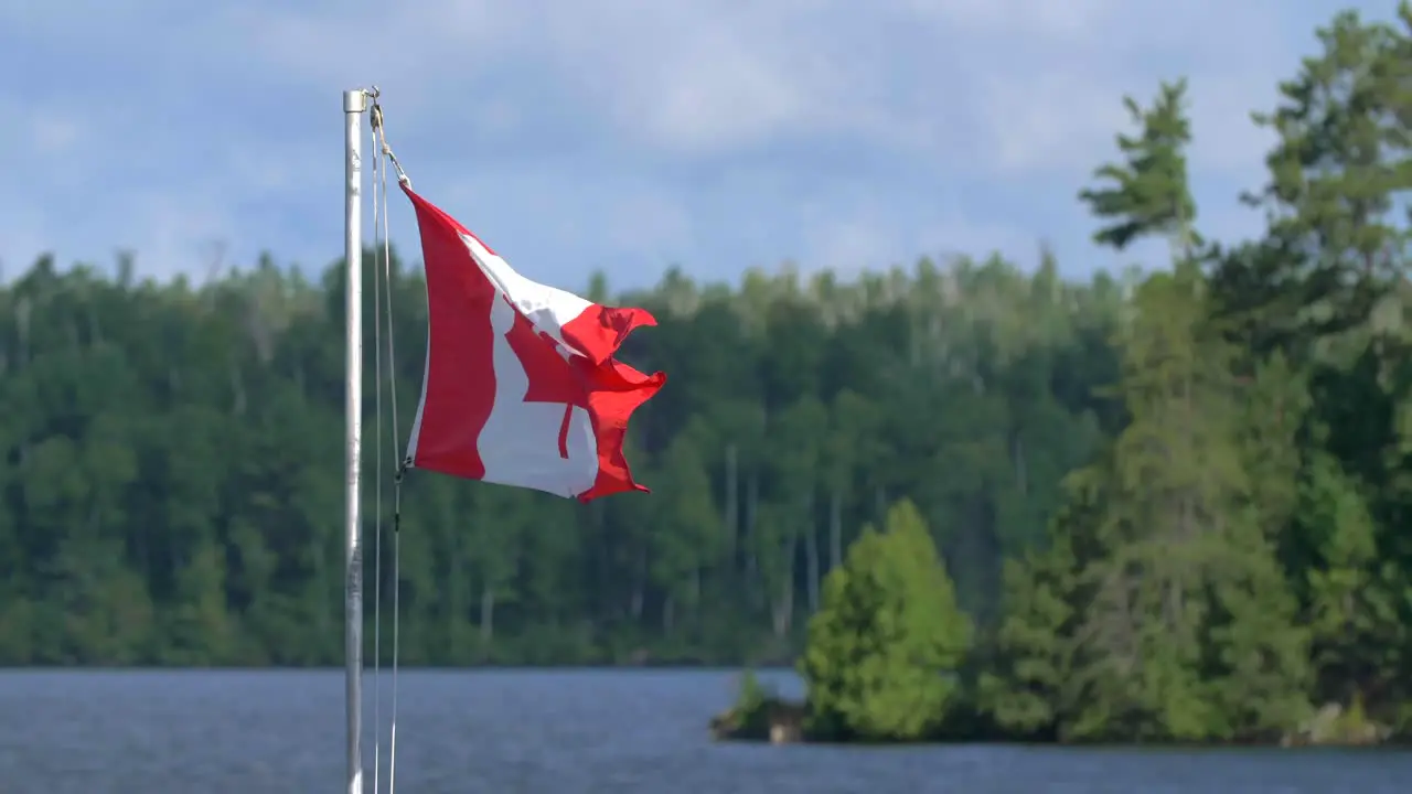 4k slow mo canadan flag tight shot flapping in the breeze quetico wilderness