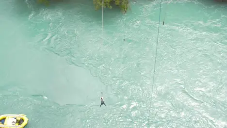 Man Bungee Jumping Over River