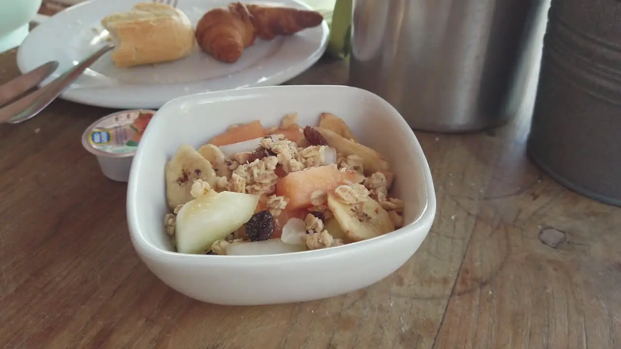 Yogurt pouring on a healthy Granola breakfast