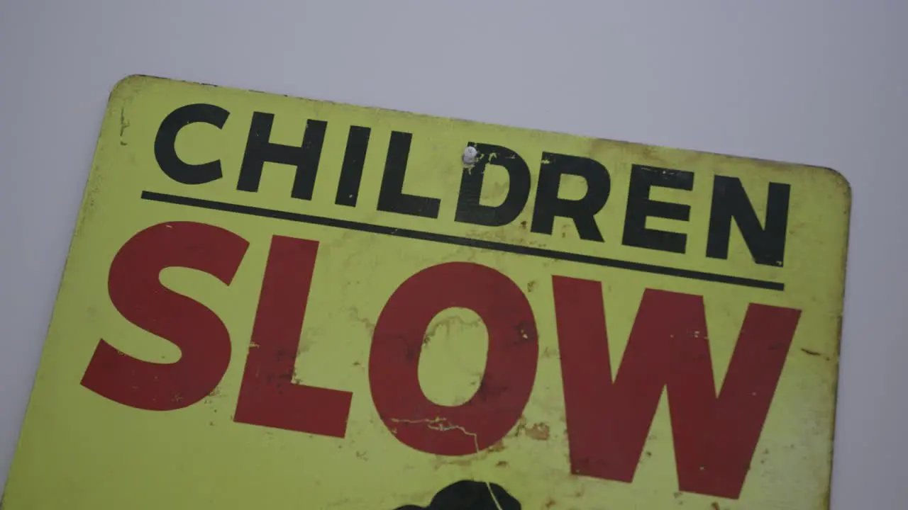 Close up footage of a road sign that says "Children SLOW