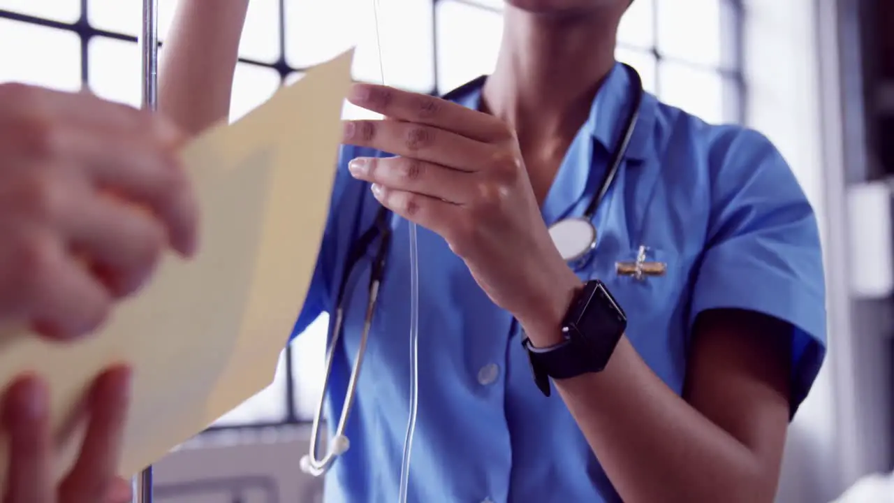 Nurse examining intravenous drip 