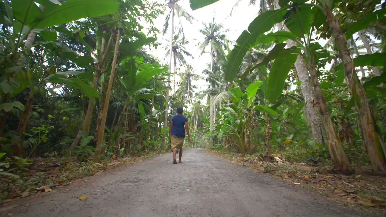 Woman Walking Down a Jungle Road