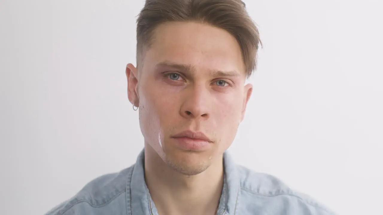 Sad Blond Man In Denim Shirt Crying