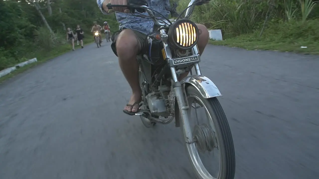 Man Riding a Scooter Through Vietnamese Countryside