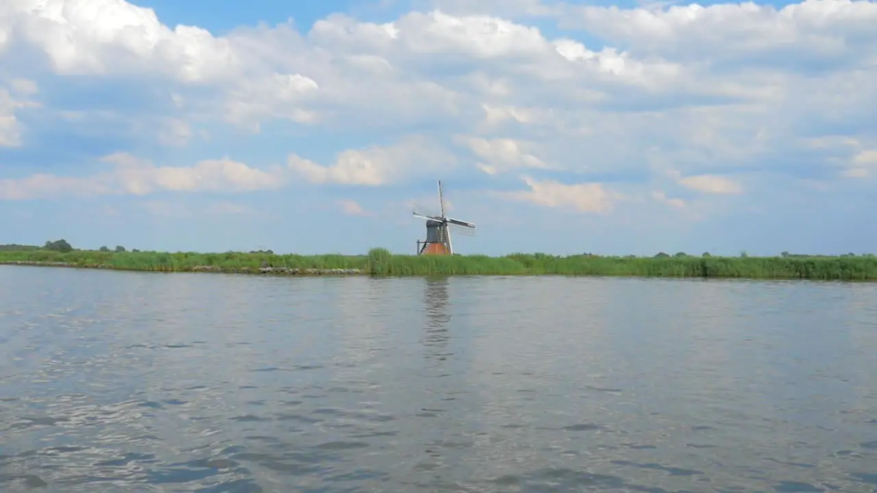 Dutch Old Windmill on a dike near the water a small Dolly shot in slowmotion