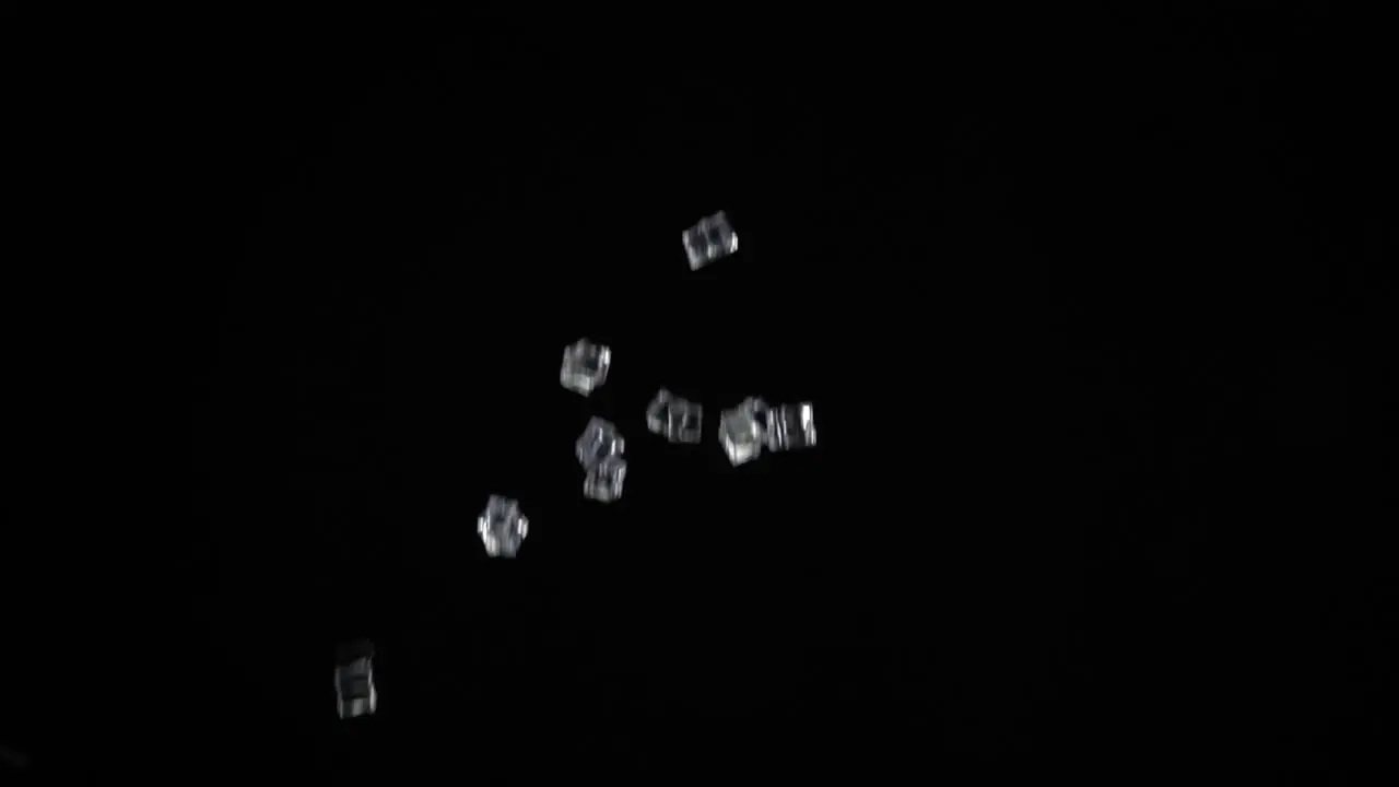 Ice Cubes launched upwards with a black background