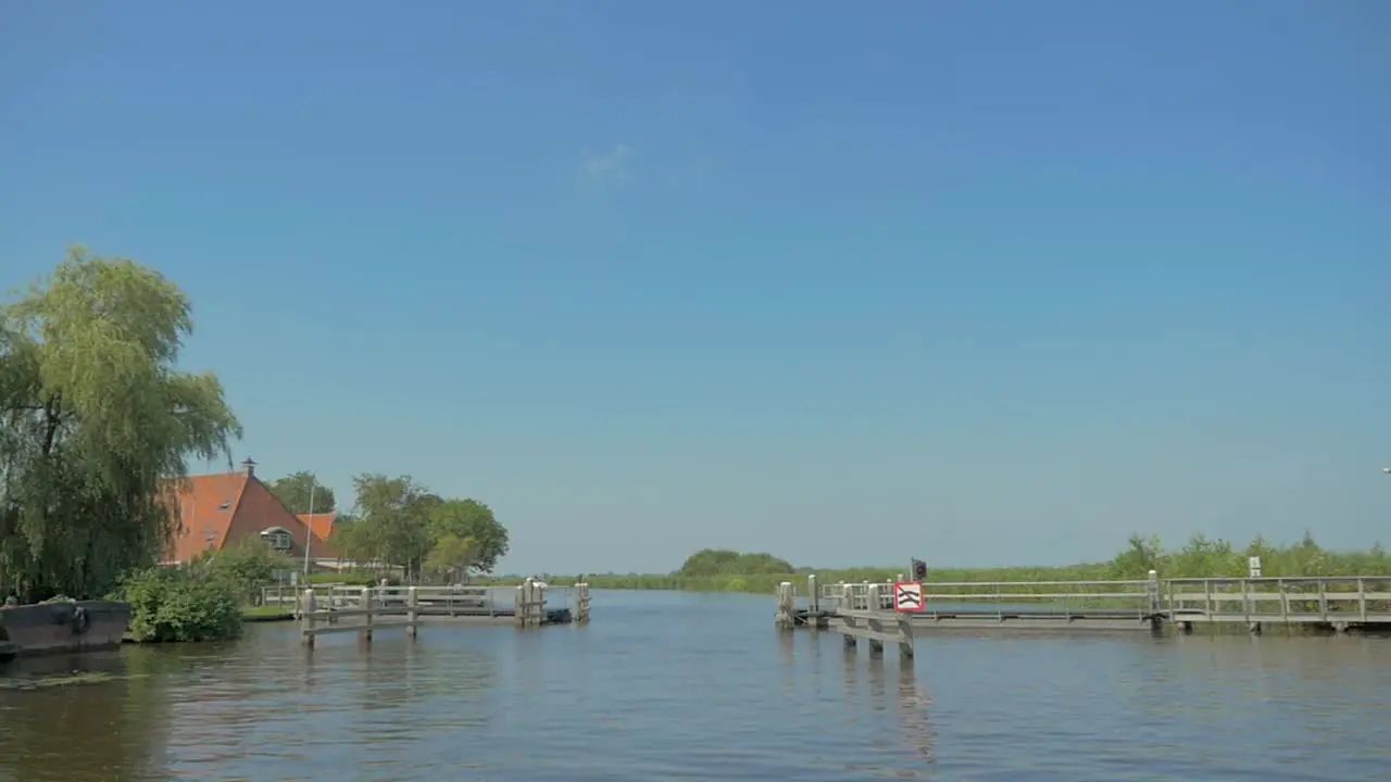 aproaching a pontoon bridge by boat in the summer in slow motion