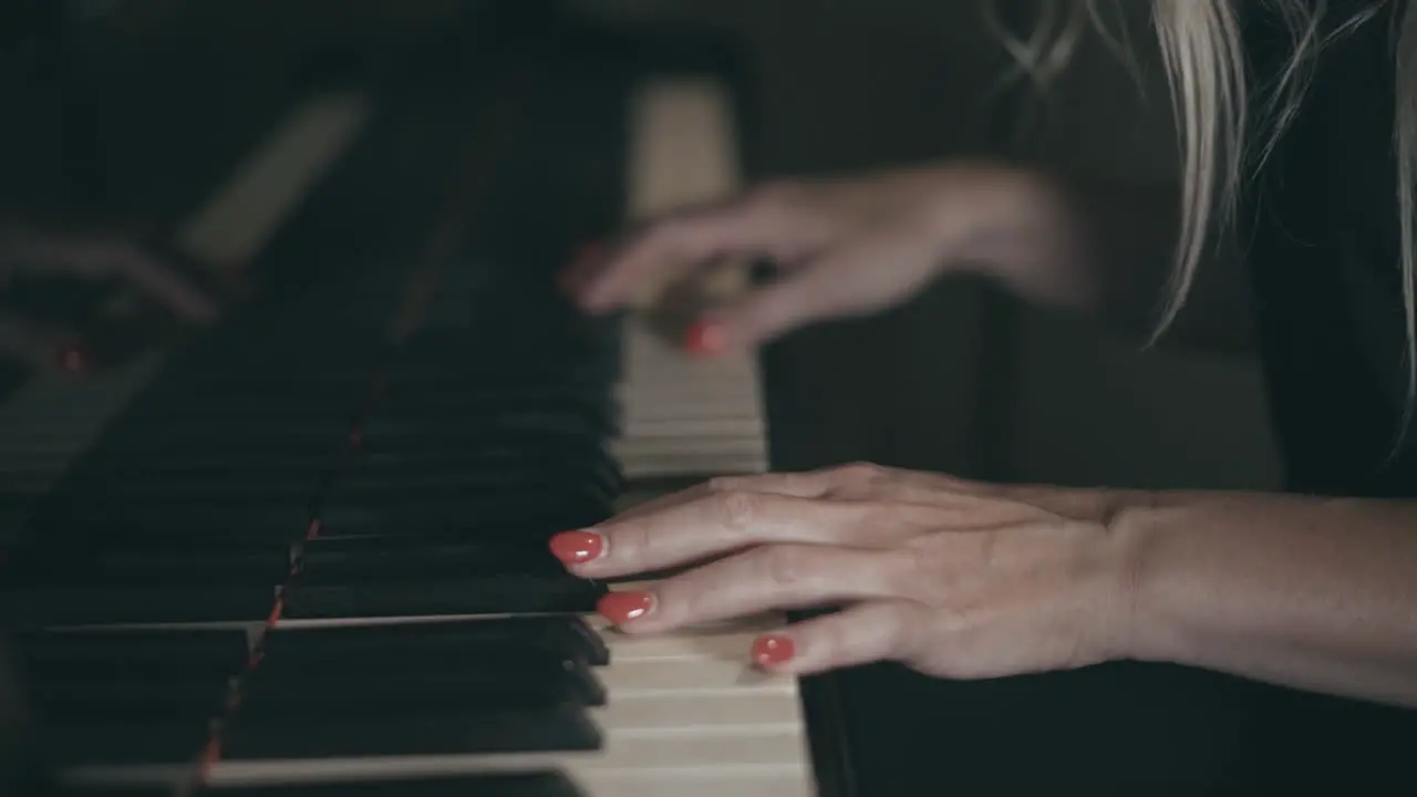 Slow motion clip of woman playing piano