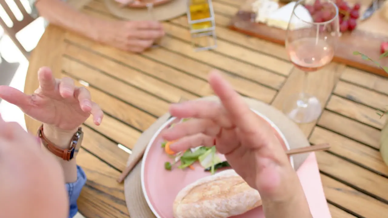 Senior people dine at an outdoor table