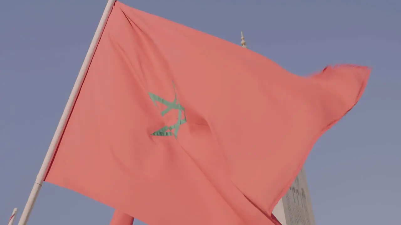 Close up of Moroccan flag flying in front of Hassan II Mosque in Casablanca