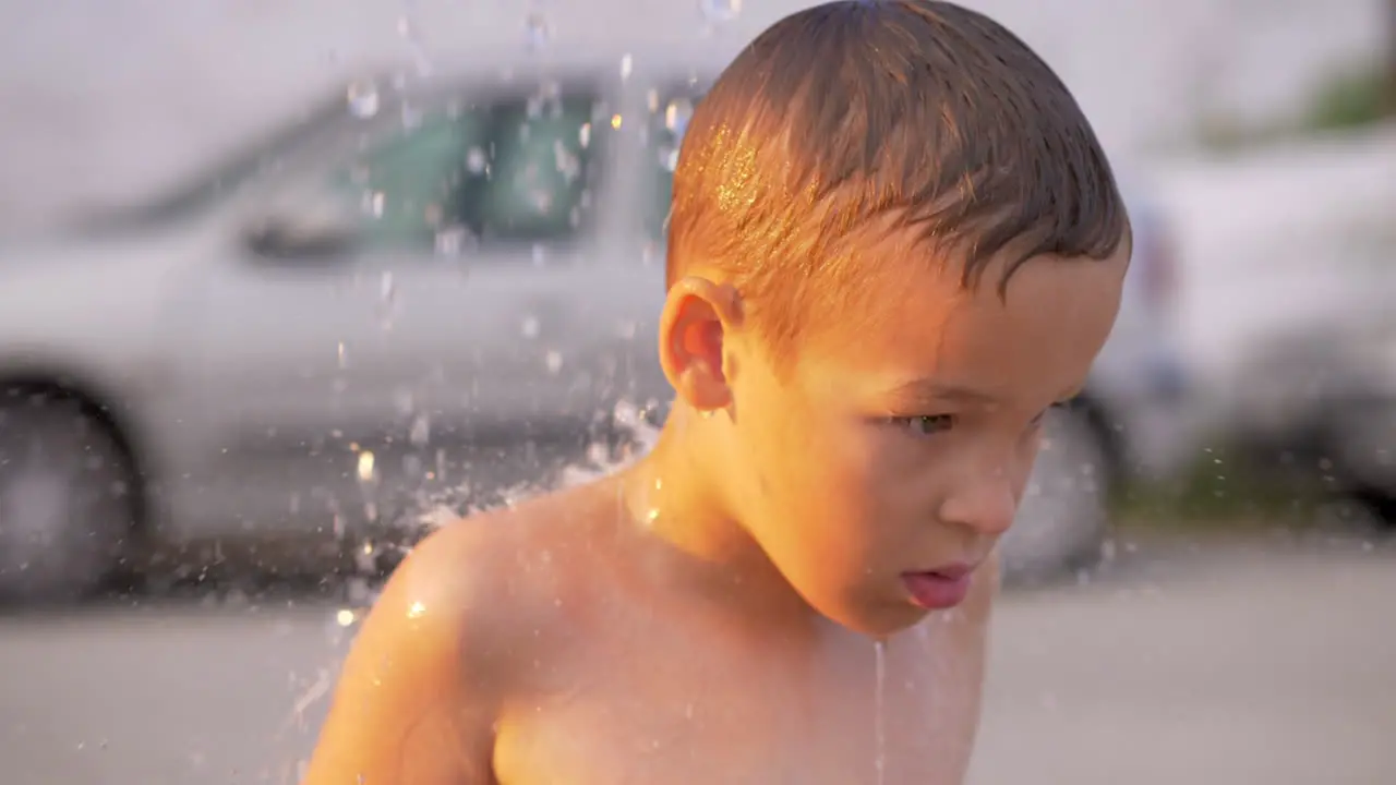 Child taking outdoor beach shower